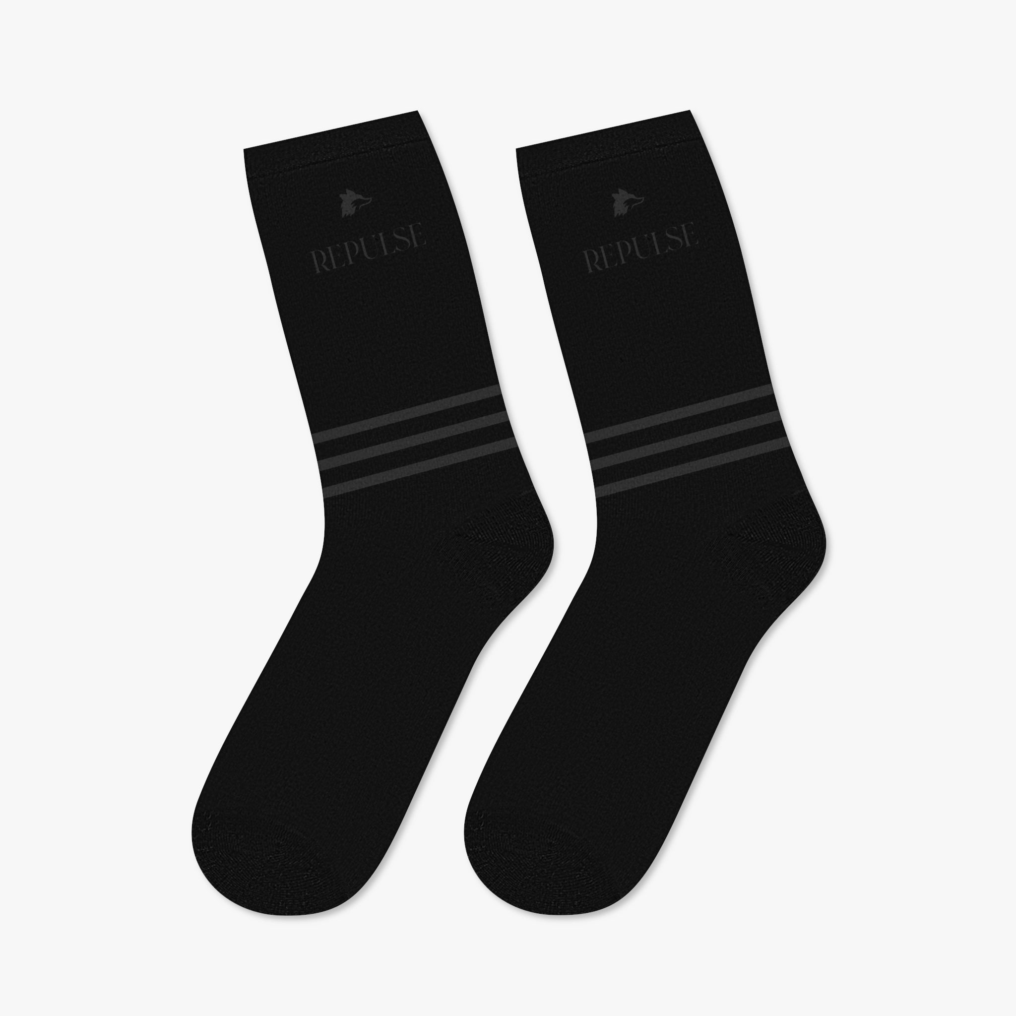 Black mid-length crew socks from the Winter '25 streetwear collection by Repulse Gaming, made from durable 200 GSM 100% polyester. Featuring a printed Repulse logo on the right side, complemented by matching stripes at the ankles. Designed for a comfortable fit with a 'one size fits most' approach, these socks blend functionality and streetwear aesthetics.